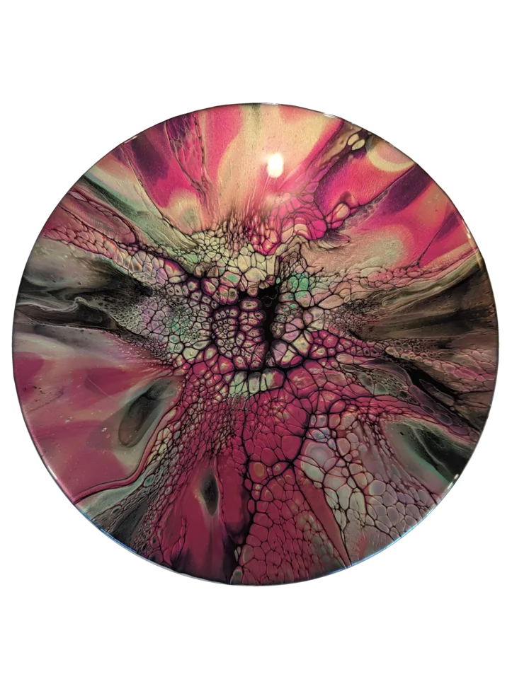 Round bloom painting in vivid pink, mint, black and cream with a dense central web.
